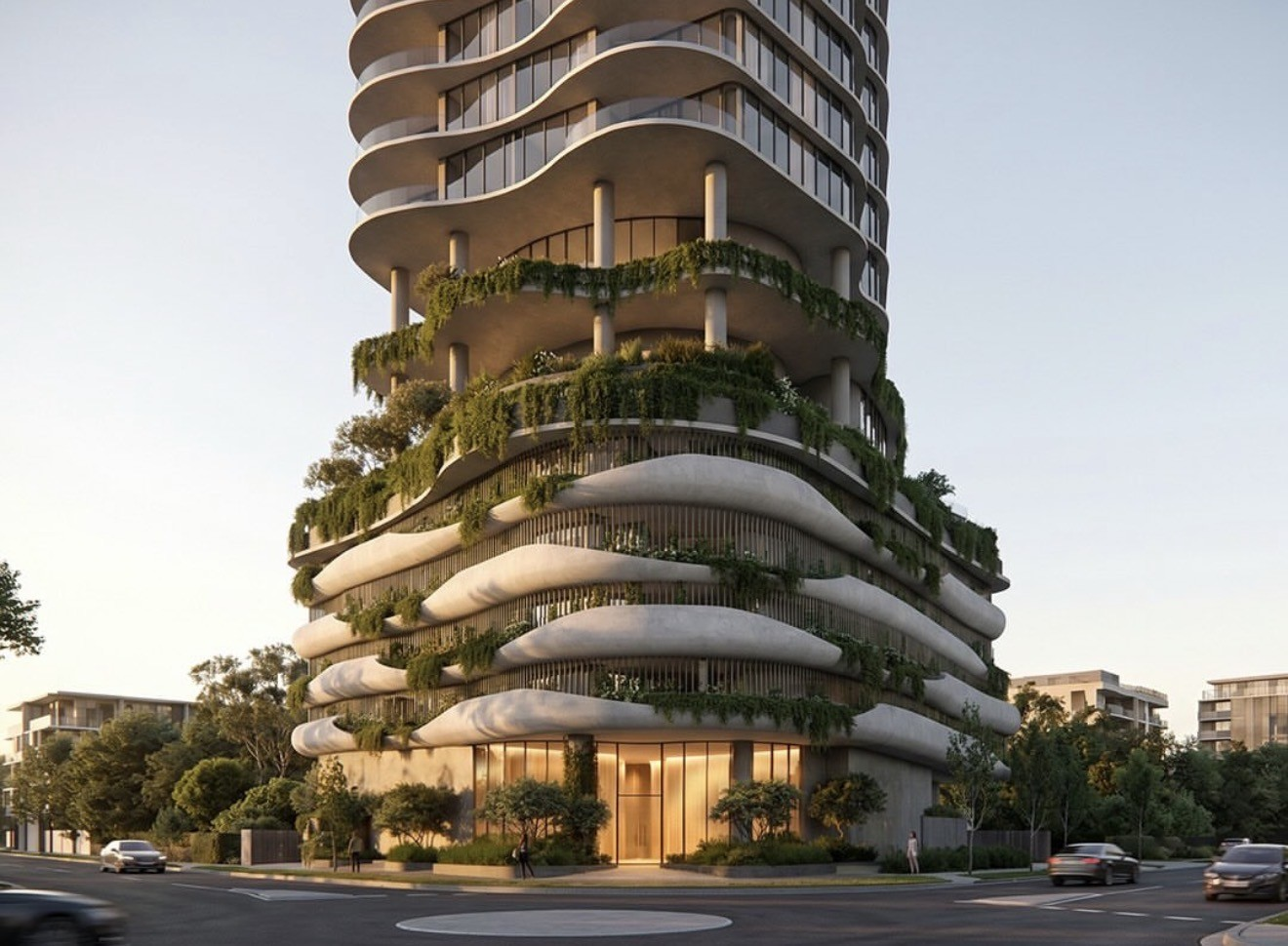 Curved high-rise tower with layered balconies and greenery at street level